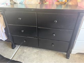 Black dresser does have some spots on top