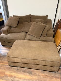Sofa with ottoman and fluffy pillows