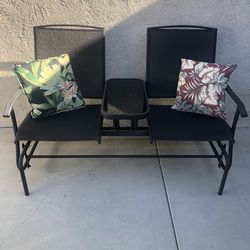 Swinging outdoor bench with table
