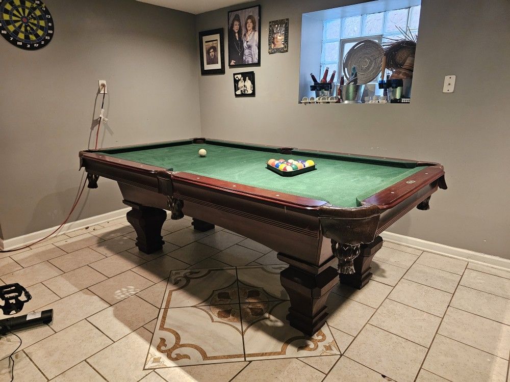Pool table, plus sticks and stick wall mount
