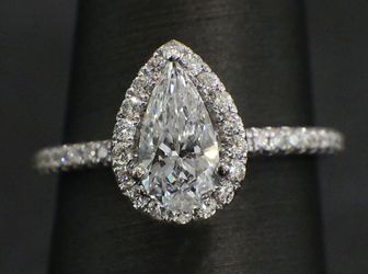 14K White Gold Engagement Ring containing a .81ct Pear Shaped Center Diamond graded color F and Clarity Si2 surrounded by 42 round diamonds