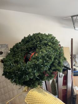 Three Christmas Door Decorations With Lights On.