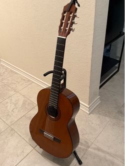 Classical guitar with stand and capo