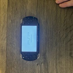 PSP with Charger, Games And Case. 