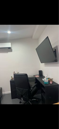 L shaped desk and swivel chair with foot rest