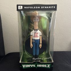 The Napoleon Dynamite Vote For Pedro Vinyl Sugar Vinyl Idolz Figure is a collectible vinyl doll featuring the iconic character from the movie Napoleon
