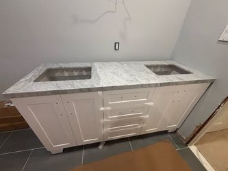 67 inch marble double sink countertop, including matching backsplash.   Cabinets not included.