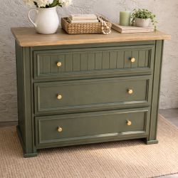 Beautiful small dresser refinished in a rich olive green with elegant gold hardware for a timeless, modern look. The top features a wood finish inspir