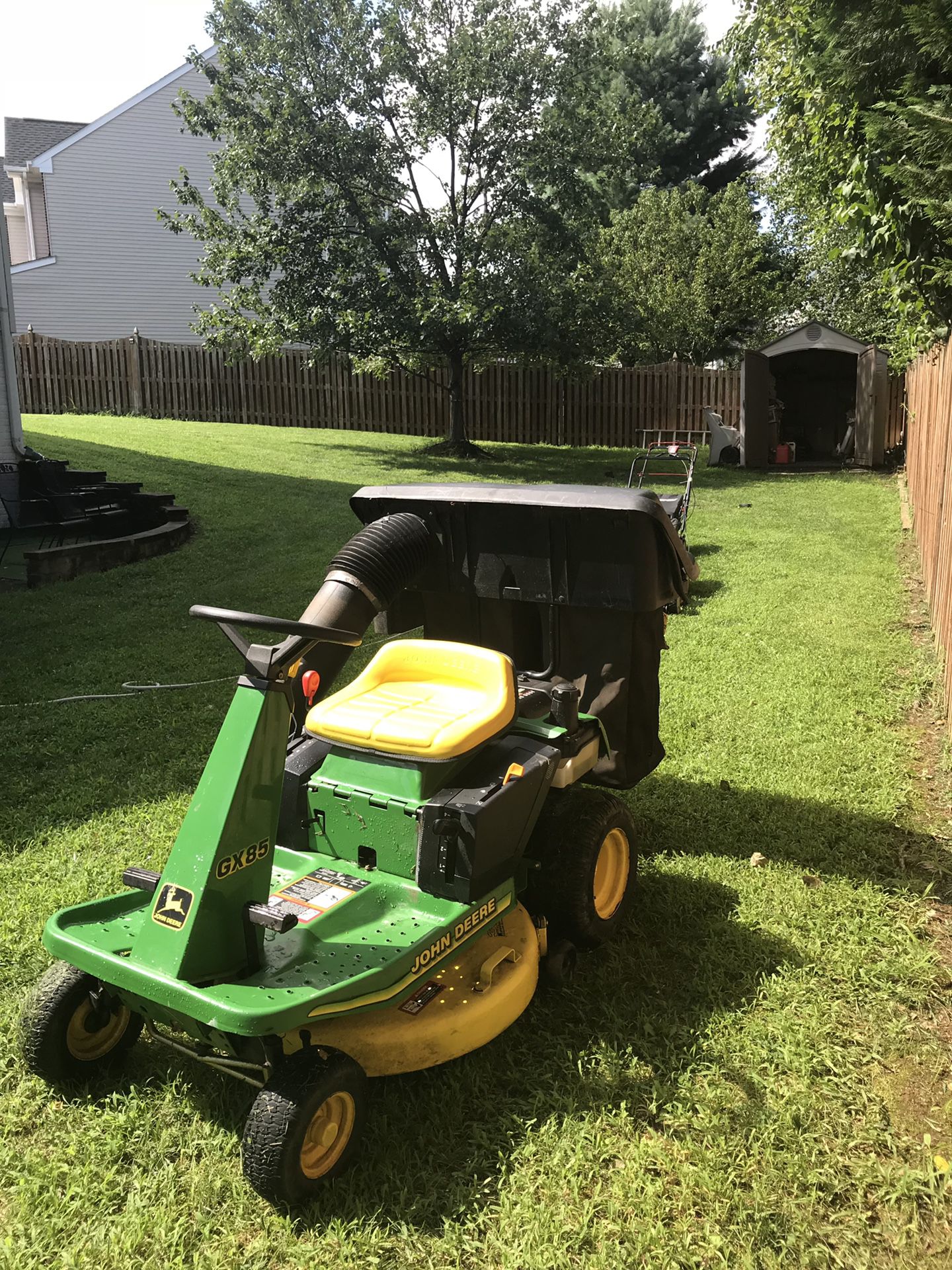 John Deere, W/two Xtra large grass collectors. Excellent running condition!