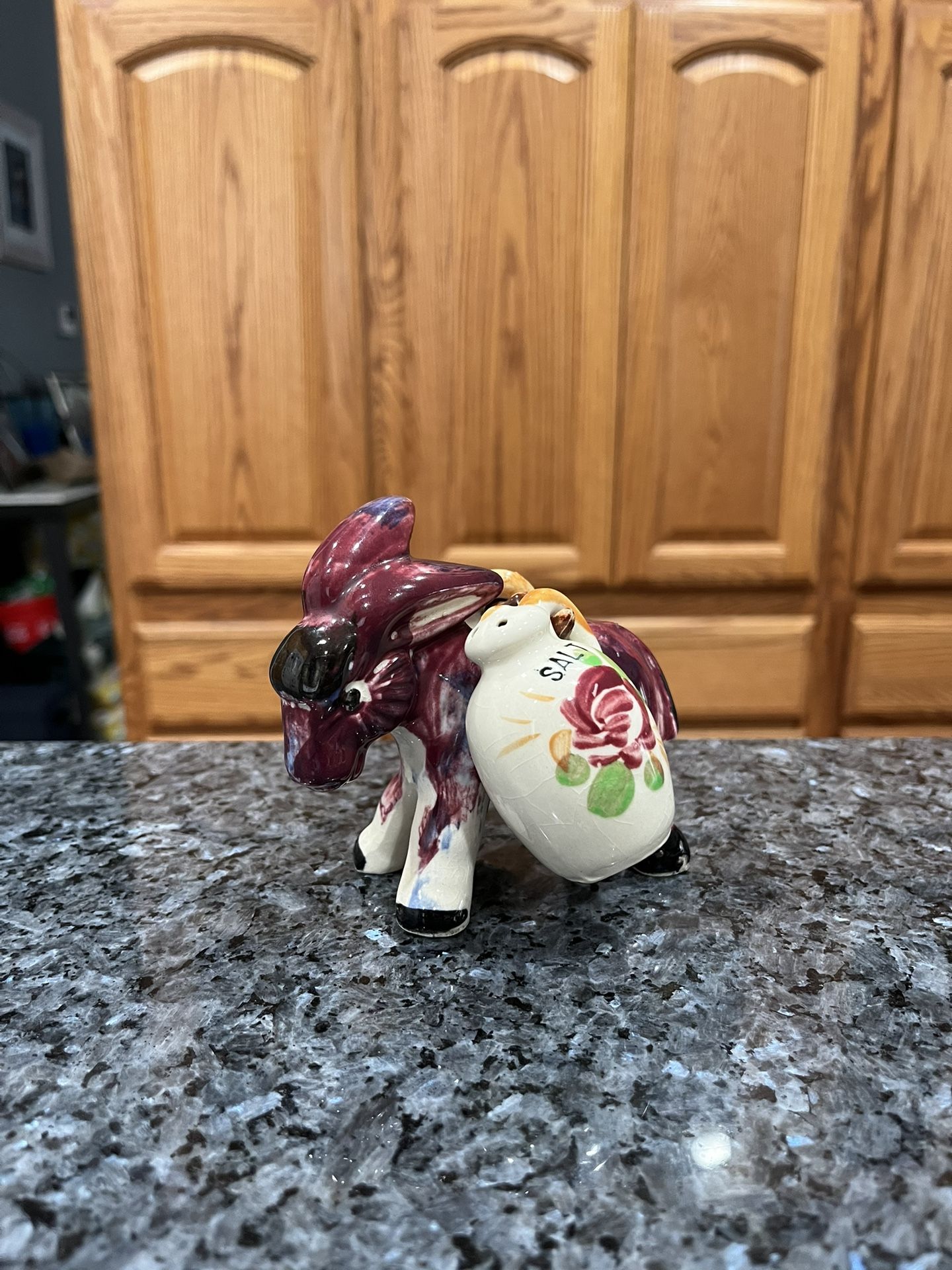 Vintage 1950's Ceramic Donkey with pair of Salt and Pepper Shakers hanging on the donkey. Preowned missing 1 Stopper