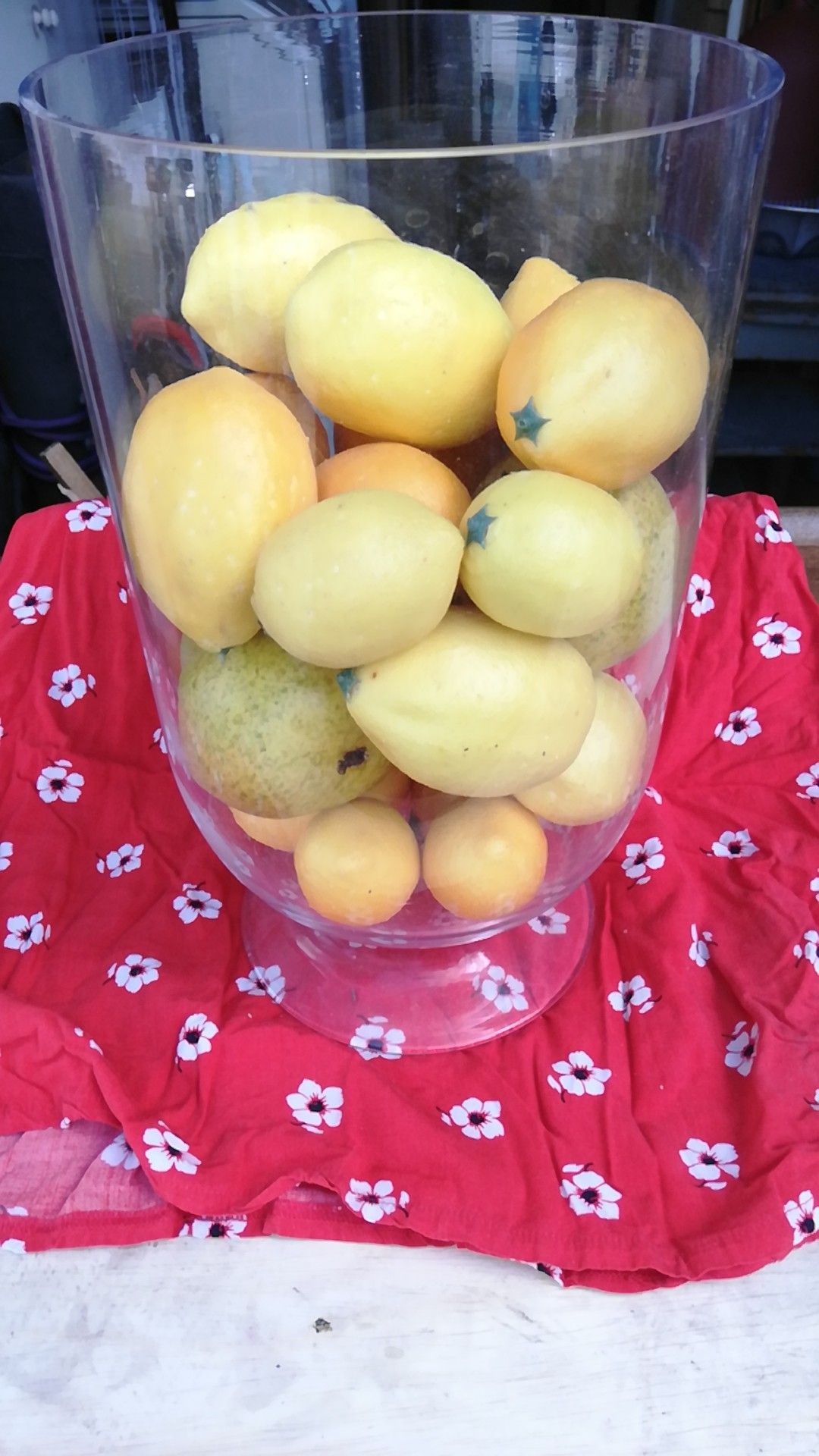 Glass decanter of plastic lemons
