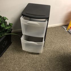 Two containers one black one white and Tyleeach with wheels