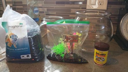 2 Fish bowls and supplies and food.