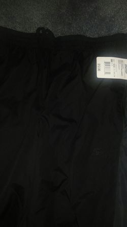 Brand new black Starter warm up pants with pockets, like a net lining, olive stripe down the side of legs, small zipper at ankles Sz S (28-30)