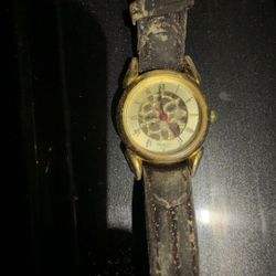 Armitron faux skeleton watch with a gold-tone case and a brown leather band