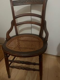 Antique wooden chairs with cane seat and carved backs