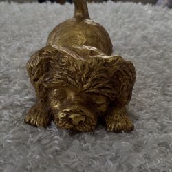 Vintage gold-colored sculpture of a Yorkshire Terrier puppy in a playful pose.