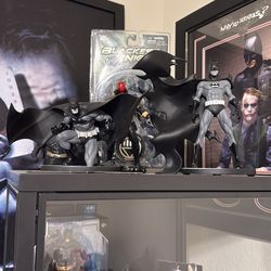 Black and white Batman statues.
