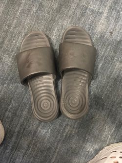 Used Under Armour slippers, size 11.