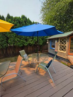 Round patio table, 2 chairs, 1 umbrella 
48"w x 28"h