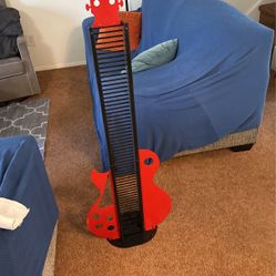 50 inch metal guitar themed CD rack in like new condition 