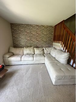 large cream faux leather sectional with a chaise