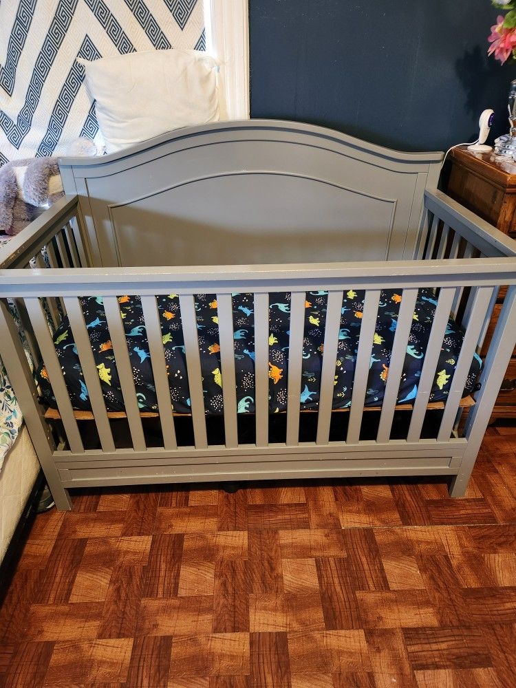 baby crib and new mattress and a baby carrier  