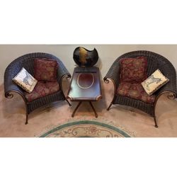 Copper accents Rattan Barrel set of 2 Armchairs with seat cushions and pillows .