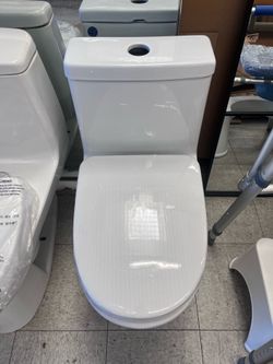 Shop Swiss Madison Sublime || 1-Piece 1.1/1.6 GPF Dual Flush Compact 24 in. Round Toilet in Glossy White Seat Included