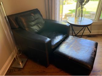 Worn leather chair and ottoman .  Very comfy