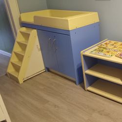 Diaper changing station with pull out steps and matching cabinet with small mickey mouse table with 2 chairs with rug for under table and some learnin