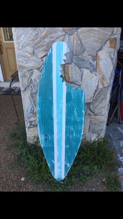Solid wood distressed hand made surfboard with shark bite