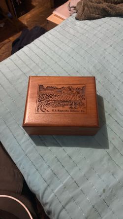 vintage wood storage box featuring laser engraving, likely produced by the Lasercraft