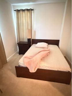 Queen bed with mattress and nightstand