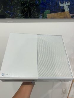 I'm selling an original Xbox One—the rare white model—complete with cables, three games, and a controller.