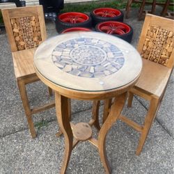 Beautiful indoor wood table and  matching pair of chairs with glass top pick up only located in Orting 