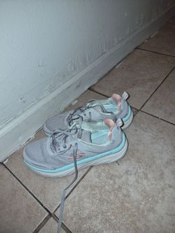 Skechers D'Lux Walker - Infinite Motion sneakers in grey with light blue and peach accents.