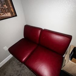 Two armless cherry red couches