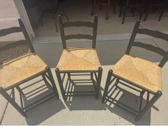 Set of 3 black ladder back counter stools with rush seats