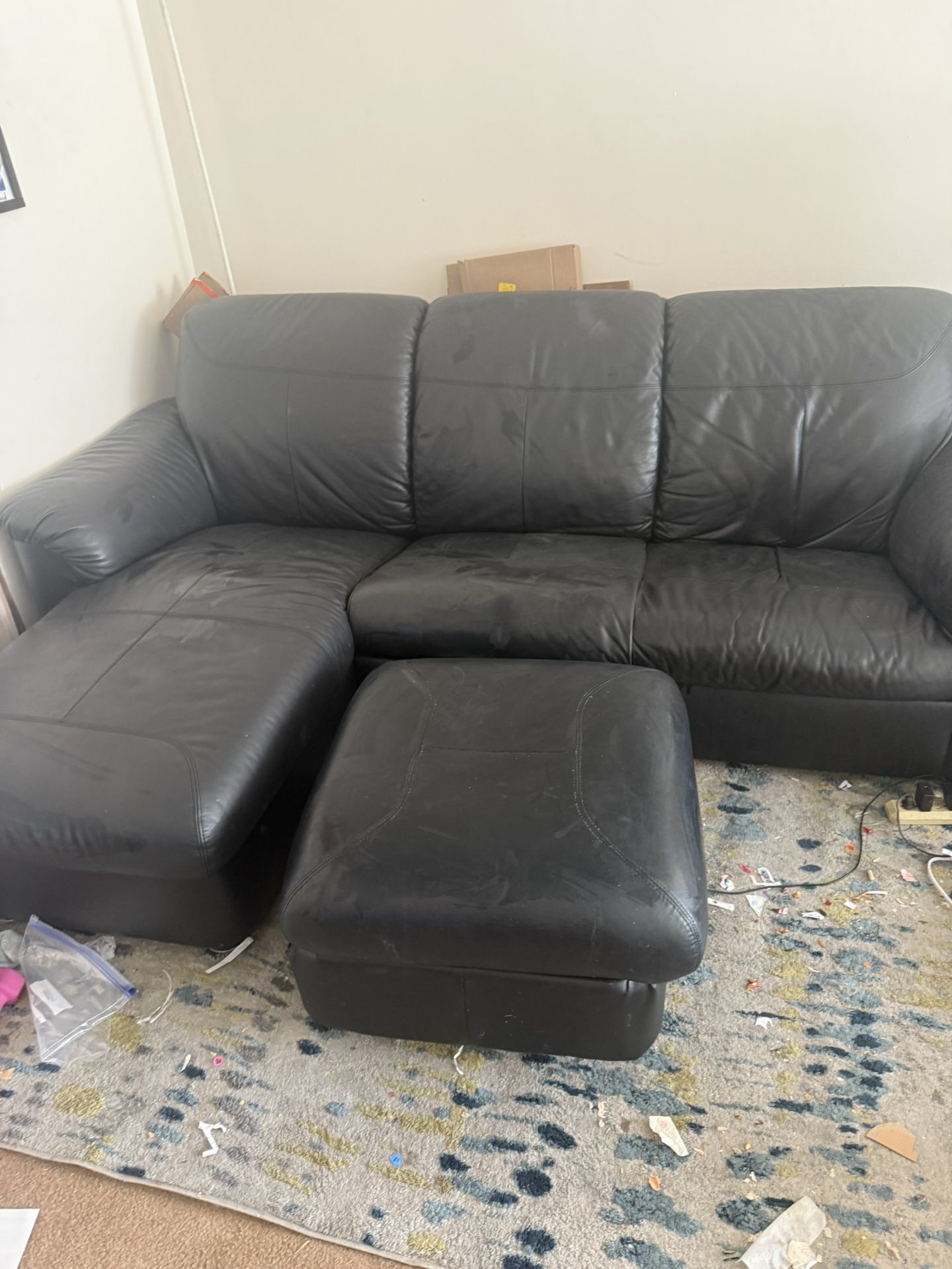Black leather couch with storable ottoman
