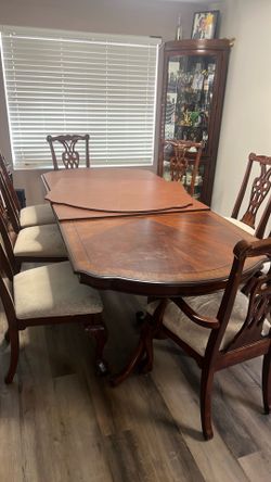 Dinning table with extension. 8 chairs. 2 chairs need cover repair