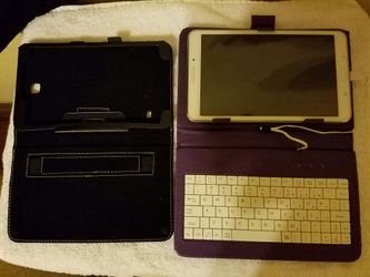 Samsung Tab 4 8" with a Purple Keyboard case & an extra Black case.