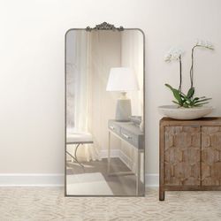 Ravena Floor Mirror, which is popular for its ornate scrollwork top and beveled glass.