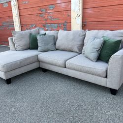 Gray sectional sofa couch with left facing chaise