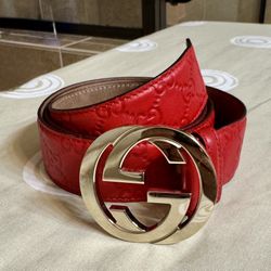 Red embossed leather with gold buckle. Minor surface scratches on buckle. Leather is in great condition.