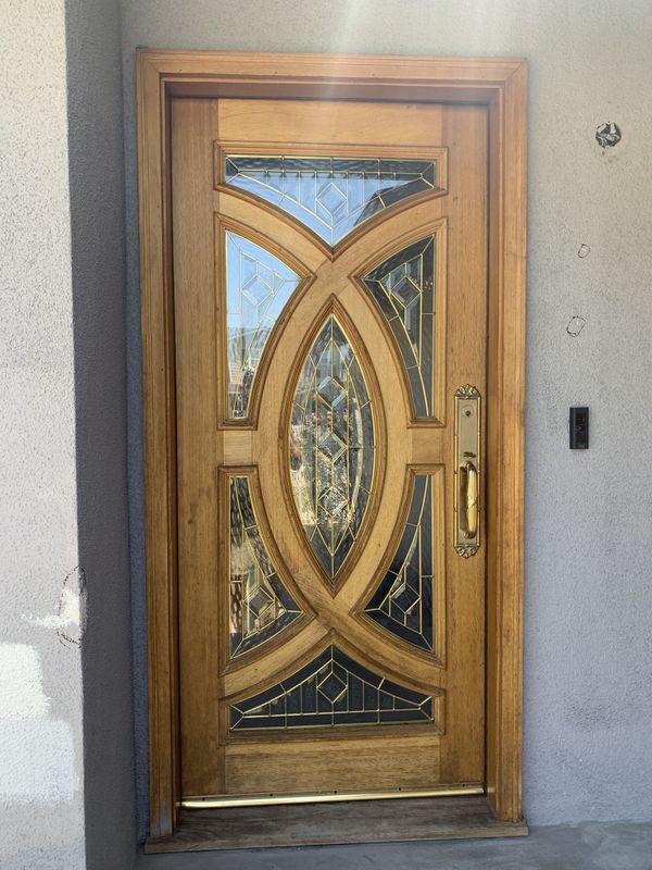 Solid oak front entry door with beveled glass & hardware for Sale in
