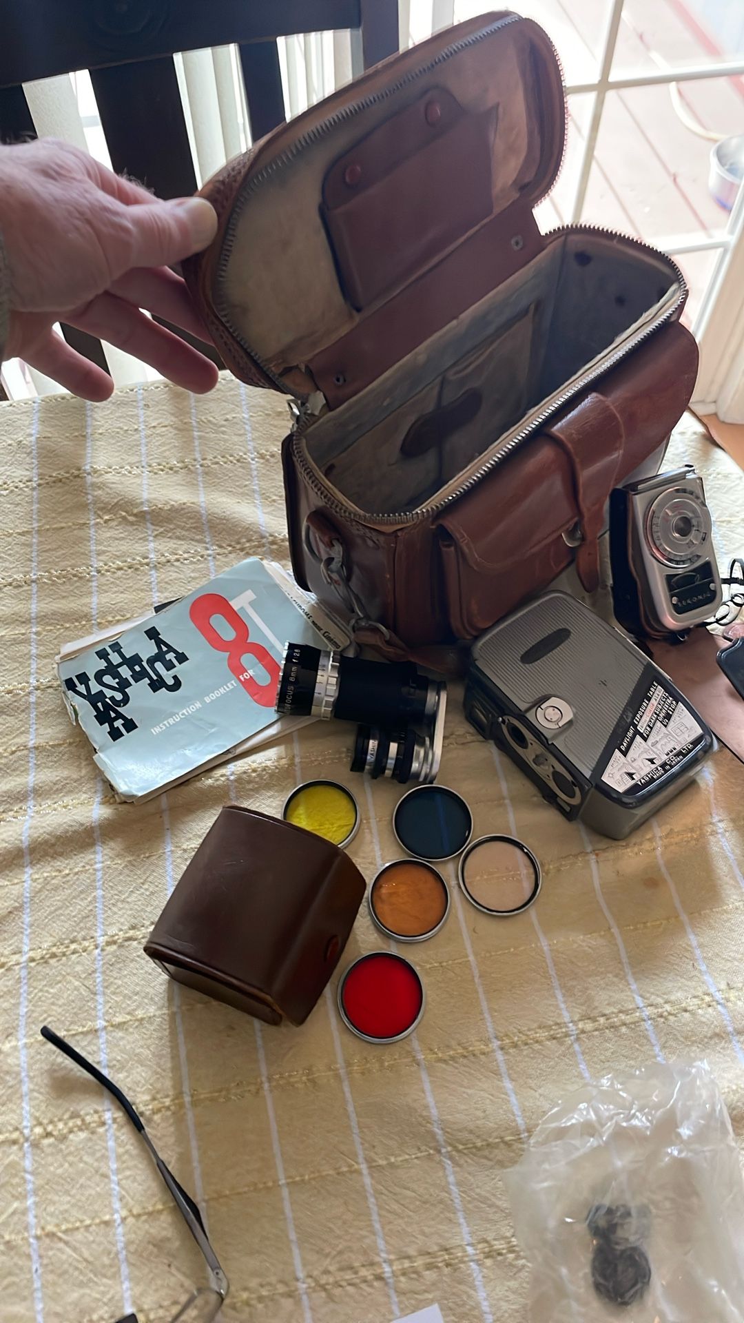 8 mm camera lots of accessories. Looks like the lens fell off, but there’s a screw in a bag. Hoping you know more about it than I.