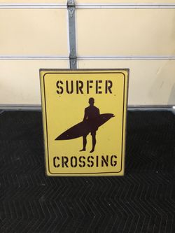 surfer crossing metal door or wall sign