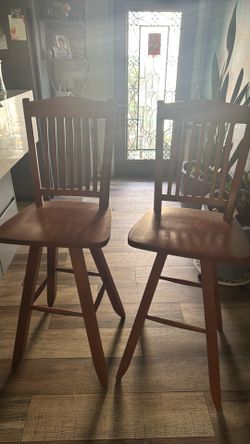 2 wooden swivel bar chairs with back
