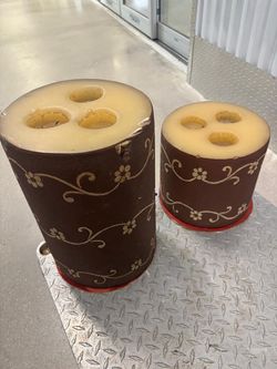 Cynlindrical silicone candle mold featuring a brown outer coating with a decorative pattern